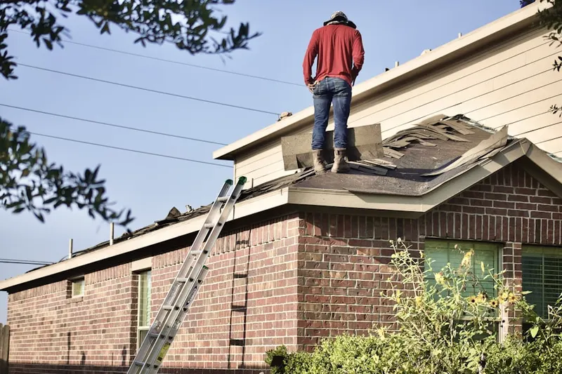 Professional roofer working on a residential roof in Ashburn Village